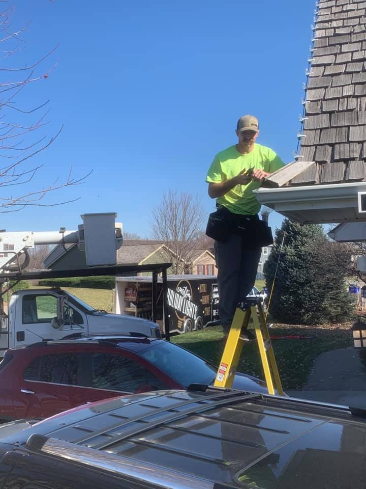 Installer on Ladder — Holiday Lights trailer